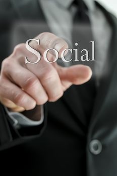 Detail of male hand pressing Social icon on a virtual screen.