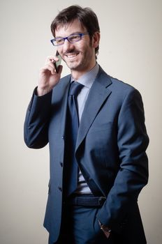 businessman on the phone on gray background