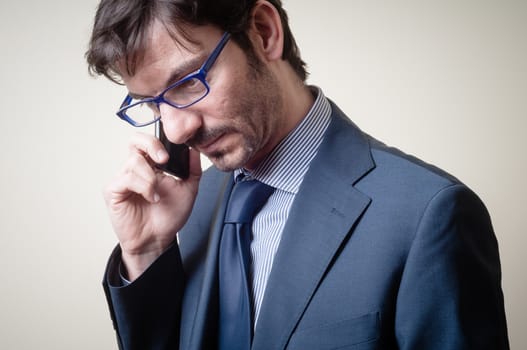businessman on the phone on gray background