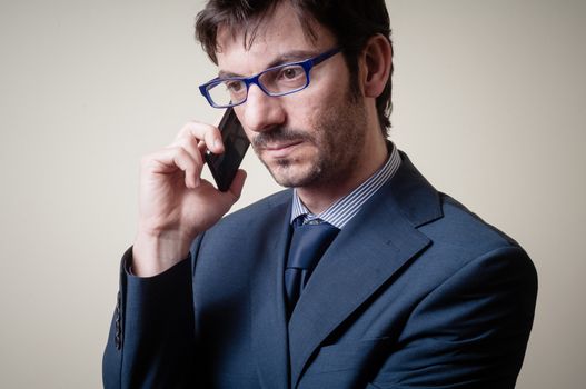 businessman on the phone on gray background