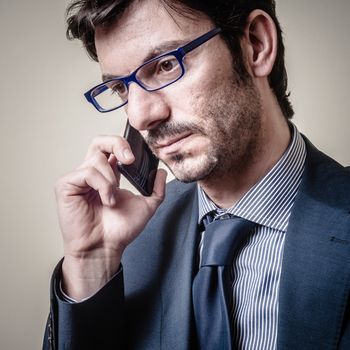 businessman on the phone on gray background