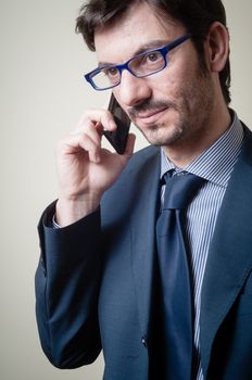 businessman on the phone on gray background