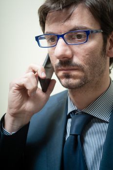 businessman on the phone on gray background