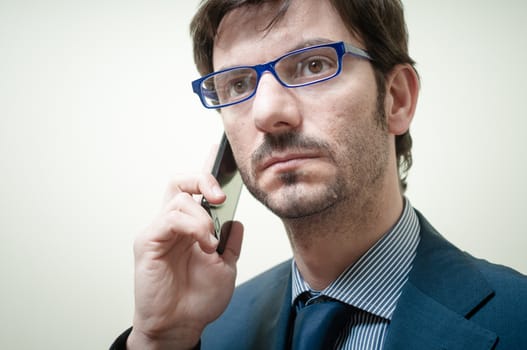 businessman on the phone on gray background
