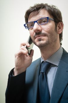 businessman on the phone on gray background