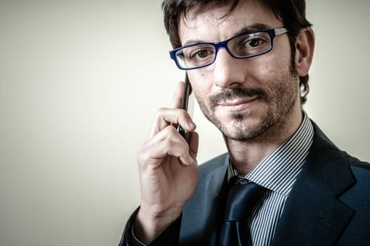 businessman on the phone on gray background