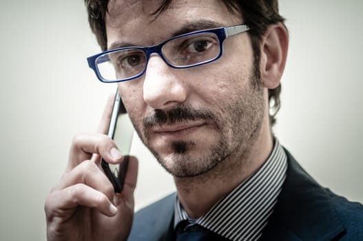 businessman on the phone on gray background