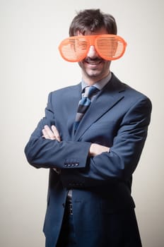 funny businessman with big orange glasses on gray background
