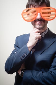 funny businessman with big orange glasses on gray background