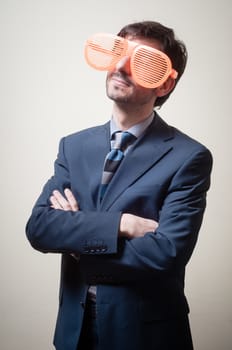 funny businessman with big orange glasses on gray background