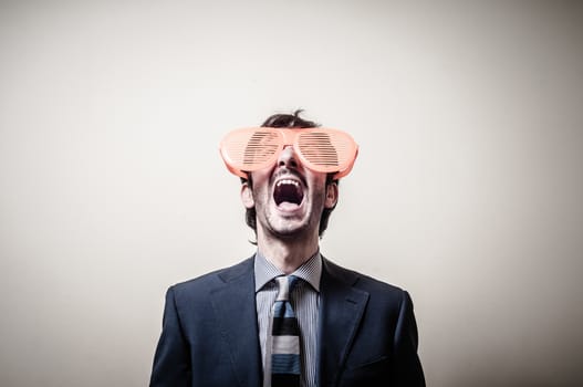 funny businessman with big orange glasses on gray background