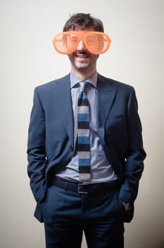 funny businessman with big orange glasses on gray background