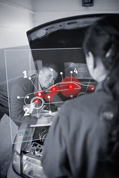 Two mechanics looking at futuristic interface with car diagram in black and white