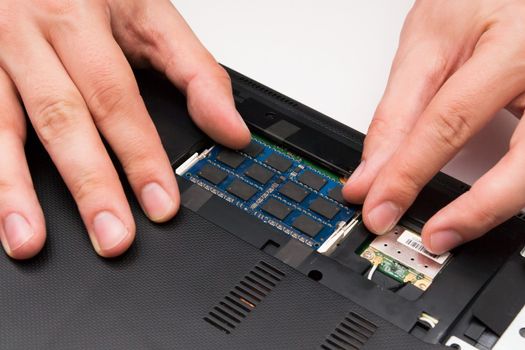 Man installing memory. Laptop RAM upgrade