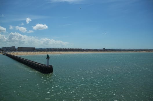 Light beacon on a pier at the entrance to Calais harbour