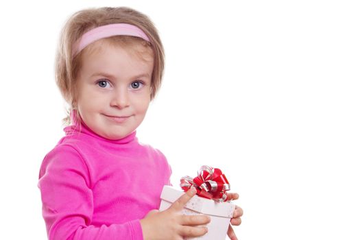 Pretty little girl in pink holding gift-box isolated over white