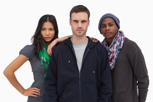 Fashionable young friends looking at camera on white background