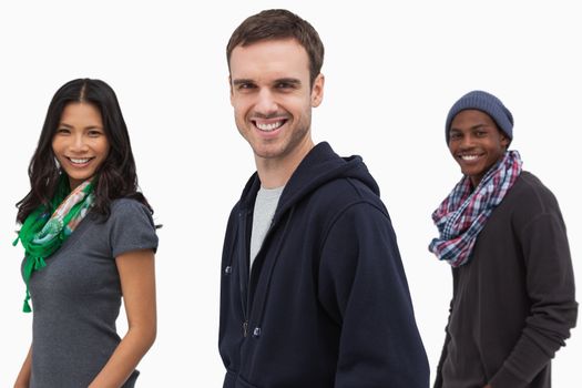 Happy stylish young people in a line on white background