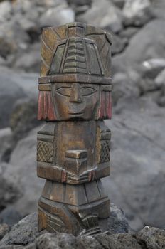 Ancient Maya Statue on the Rocks near the Ocean