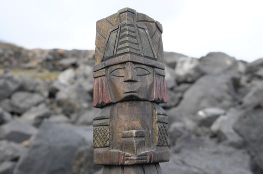 Ancient Maya Statue on the Rocks near the Ocean