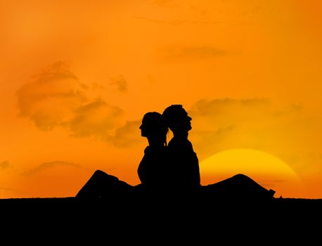 Silhouette of couple relaxing under a sunset back to back