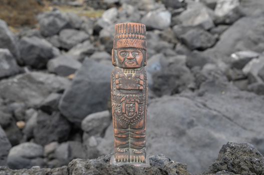 Ancient Maya Statue on the Rocks near the Ocean