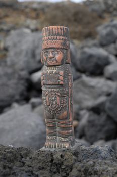 Ancient Maya Statue on the Rocks near the Ocean