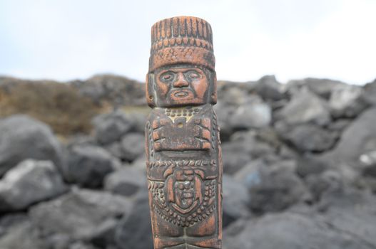 Ancient Maya Statue on the Rocks near the Ocean