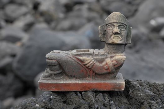 Ancient Maya Statue on the Rocks near the Ocean