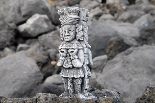 Ancient Maya Statue on the Rocks near the Ocean