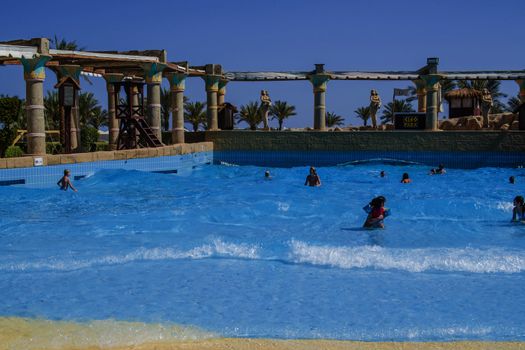 The children thrive with swimming in a wave pool at Cleo water park located at the hotel Hilton Sharm Dreams Naama Bay, Egypt.