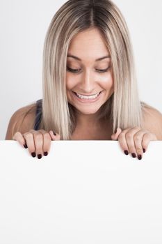 Young blond woman holding a white board