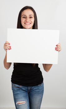 Young brunette woman holding a white board