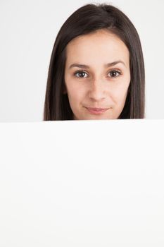 Young brunette woman holding a white board