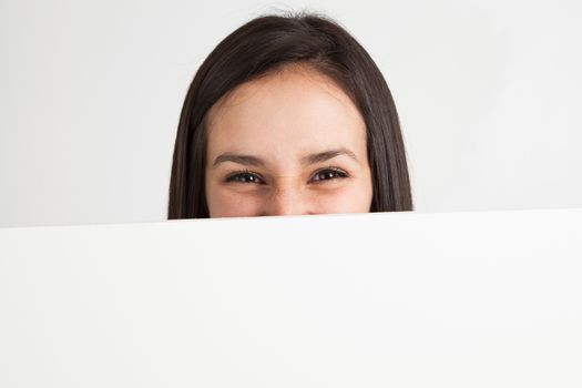 Young brunette woman holding a white board