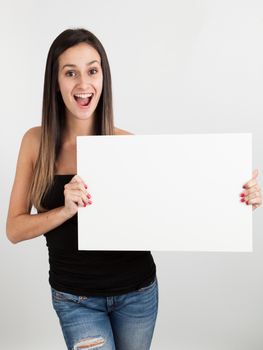 Young brunette woman holding a white board