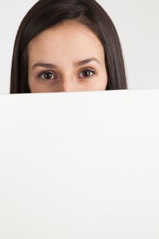 Young brunette woman holding a white board