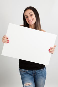 Young brunette woman holding a white board