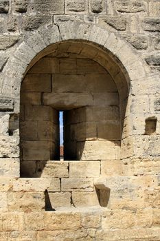 Close up on one loop hole in famous fortification wall surrounding Aigues-Mortes city, Camargue, France