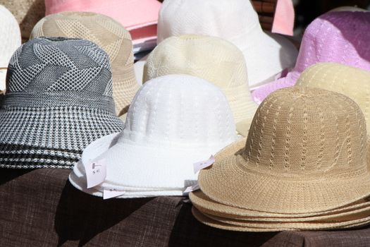 Close up on several women sun hats for sale