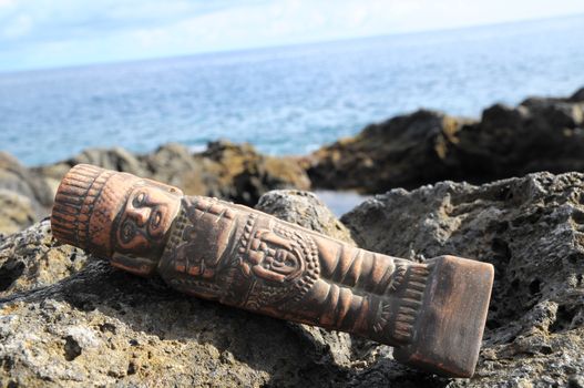 Ancient Maya Statue on the Rocks near the Ocean