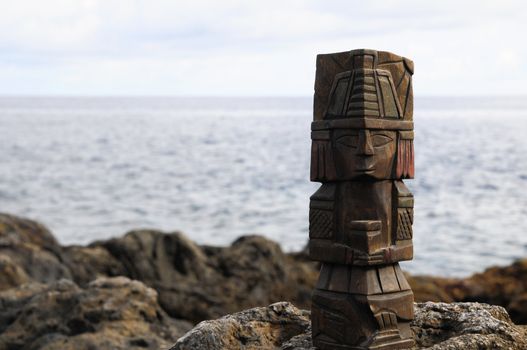 Ancient Maya Statue on the Rocks near the Ocean