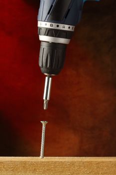 Electric screwdriver with screw, close up