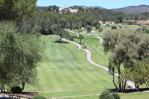 Aerial view of the greens and fairways of a golf course stretching off into the distance