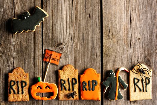 Halloween homemade gingerbread cookies over wooden table