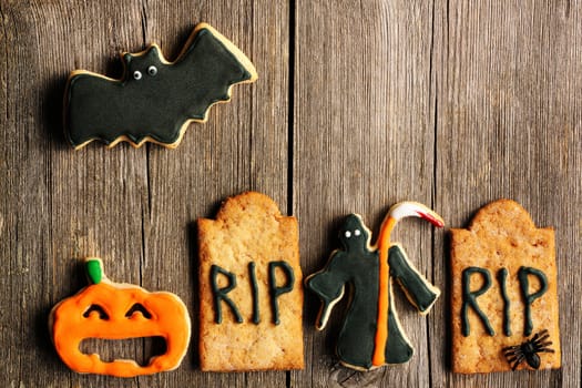 Halloween homemade gingerbread cookies over wooden table