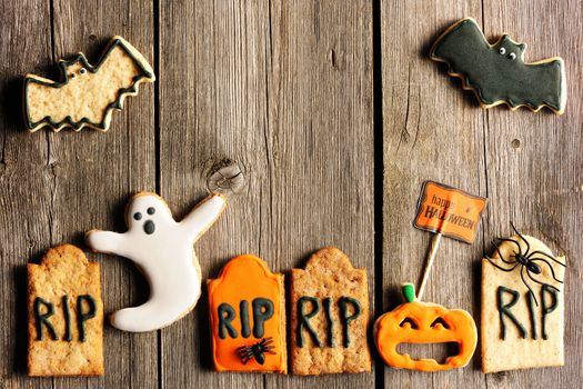 Halloween homemade gingerbread cookies over wooden table