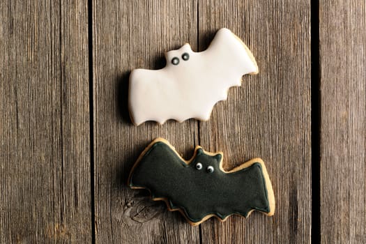 Halloween homemade gingerbread cookies over wooden table