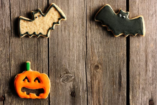 Halloween homemade gingerbread cookies over wooden table