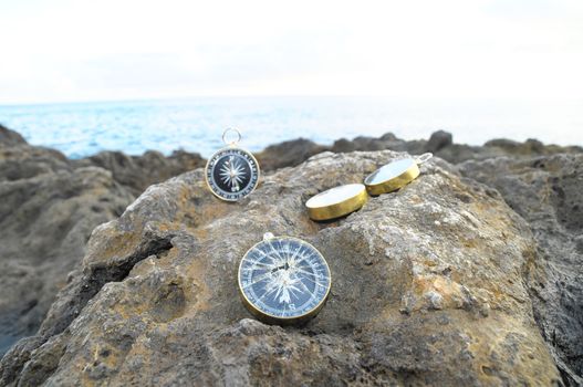 Orientation Concept - Analogic Compass Abandoned on the Rocks